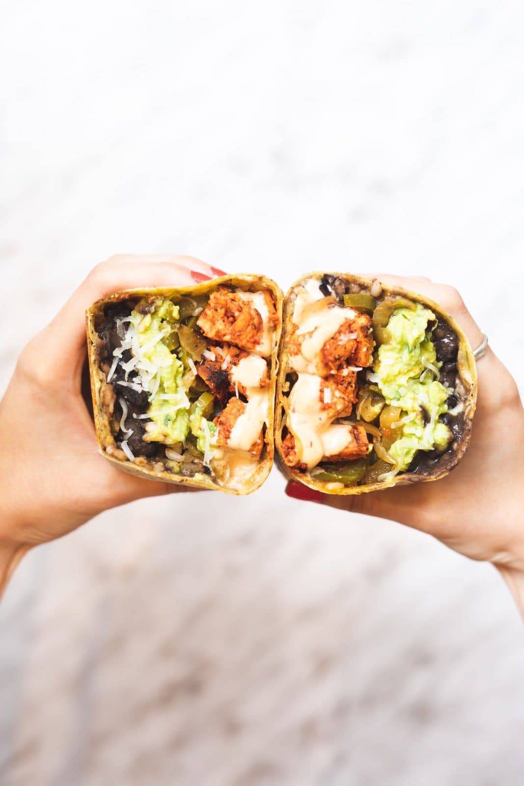 A hearty loaded burrito with grilled meat, beans, rice and guacamole at Juanito's Tacos