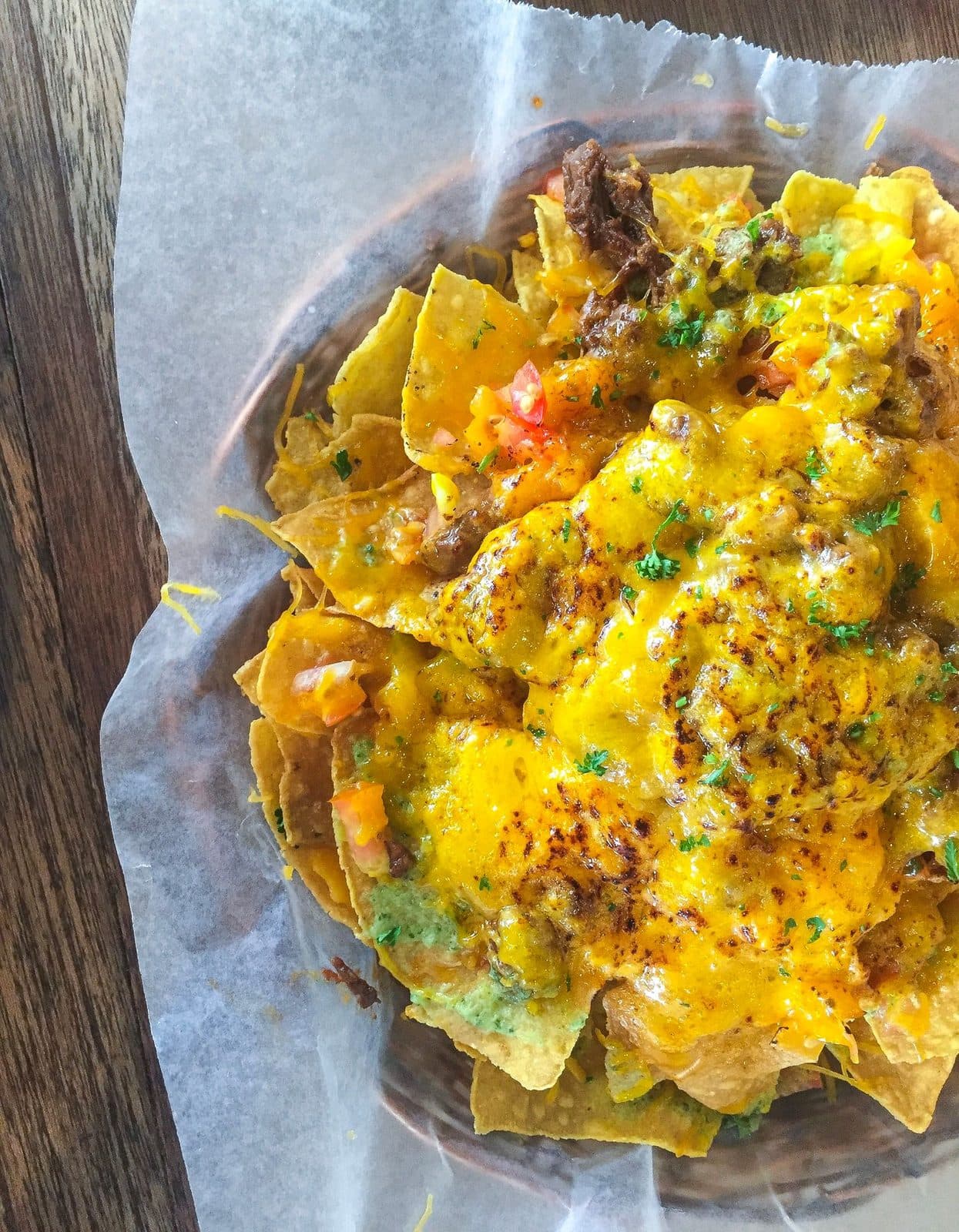 Loaded nachos with melted cheese, meat and pico de gallo at Juanito's Tacos